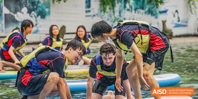 A group of students smiling and participating in a water activity at Yew Chung International School of Shanghai.