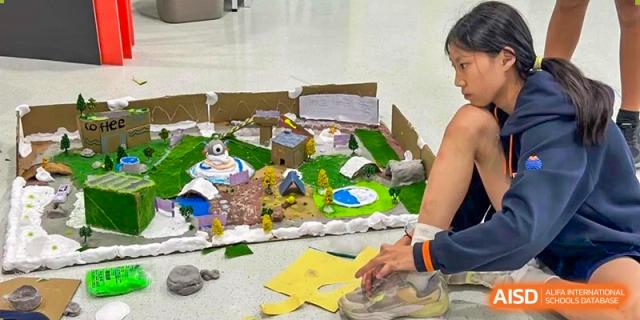 Students building a diorama or model city for a school project at Yew Wah International Education School of Shanghai Lingang.
