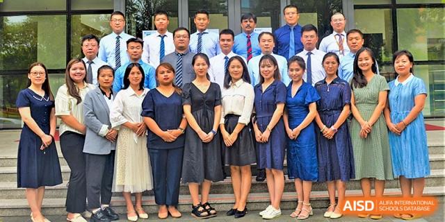 A group of staff and teachers posing for a photo at Yew Wah International Education School of Shanghai Lingang.