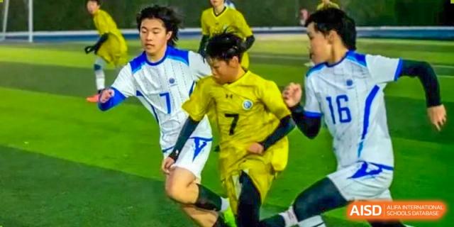 Student playing soccer during a sports event at Yew Wah International Education School of Shanghai Lingang.