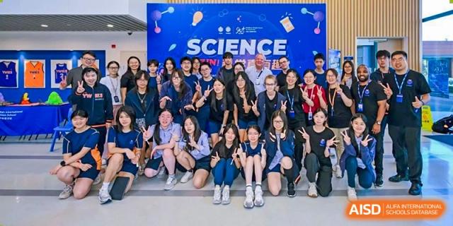 Group of students and teachers smiling for a photo at Yew Wah International Education School of Shanghai Lingang.