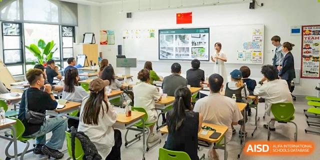 Students and parents from Dingwen Academy Hangzhou attending a presentation or meeting in a large classroom setting.