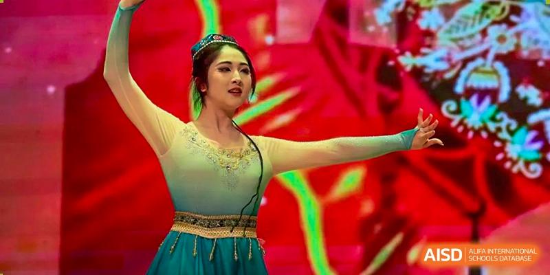 A student from International Department of Jinling High School Hexi Campus performing a traditional or contemporary dance on stage.