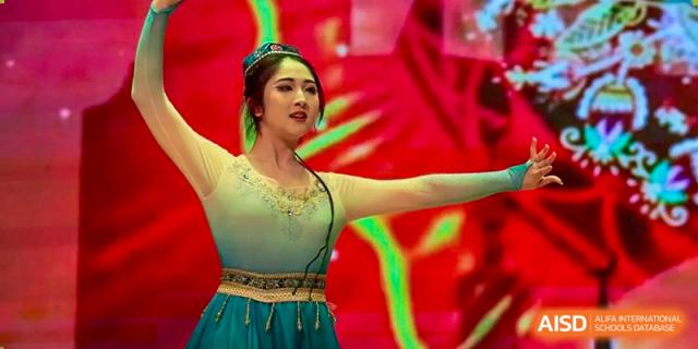 A student from International Department of Jinling High School Hexi Campus performing a traditional or contemporary dance on stage.