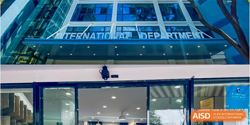 Close-up view of the exterior of a building entrance with "INTERNATIONAL DEPART..." visible, representing the International Department of Jinling High School Hexi Campus.