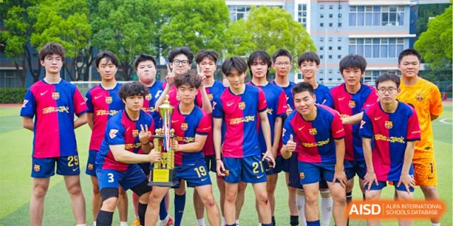 A group of male students from the soccer team of International Department of Jinling High School Hexi Campus posing with a trophy on the field after a victory.