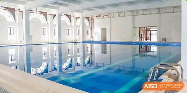 The bright, indoor swimming pool facility at the Guangdong Overseas Chinese High School International Curriculum.