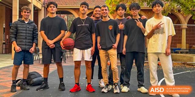 A group of male Wuhan Weiming Senior High School students and friends posing together outdoors, holding a basketball.