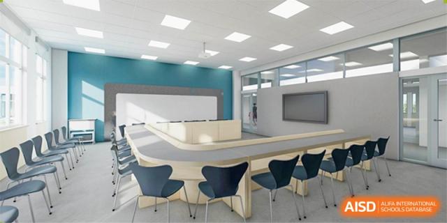 A modern, empty classroom or seminar room at Wuhan Weiming Senior High School with flexible seating and a curved desk.