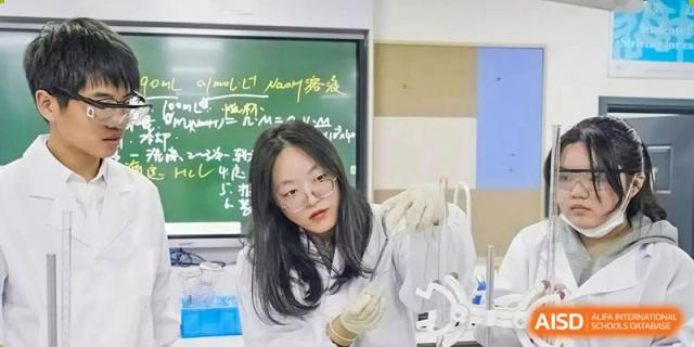 A female student in a lab coat and glasses holding a beaker during a science experiment at the Shanghai Jincai High School International Division.