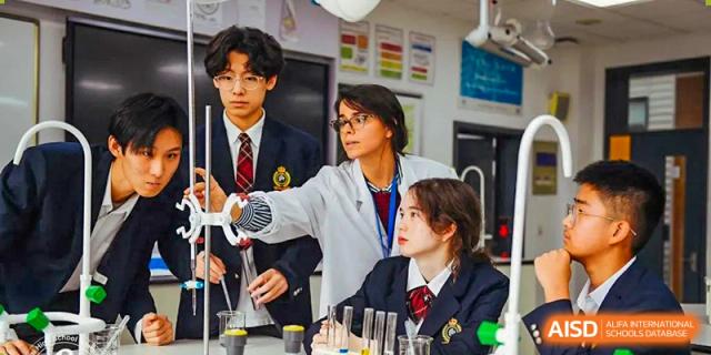 A group of students in a science lab working with beakers and other lab equipment at the Shanghai Jincai High School International Division.