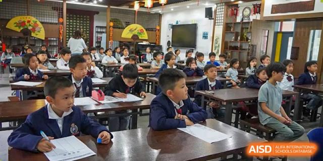 Students sitting at desks looking toward the front of the classroom during a lesson at the Shanghai Jincai High School International Division.