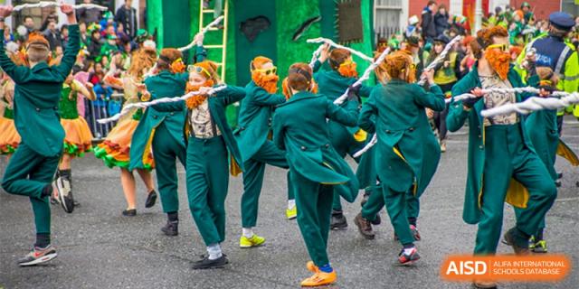 A group of students in bright green uniforms participating in a synchronized dance or performance outdoors. Canada British Colombia International Schools-Hefei.