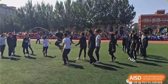 Students participating in a casual outdoor dance or group activity on a grassy area. Canada British Colombia International Schools-Hefei.