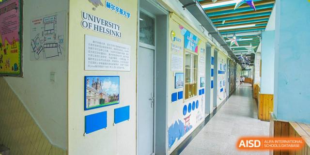 A school hallway at Wuhan Foreign Languages School International Division featuring a display about the University of Helsinki.