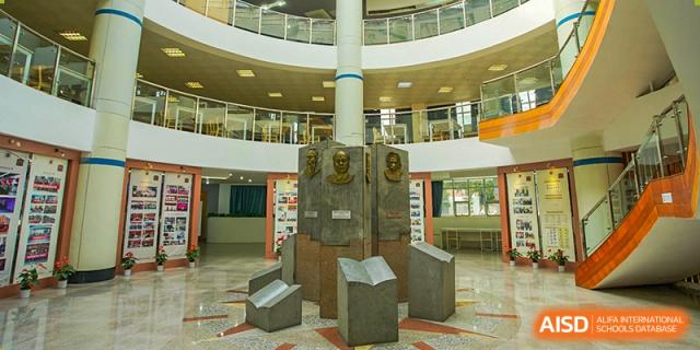 A central sculpture or monument display in the lobby or atrium of Wuhan Foreign Languages School International Division.