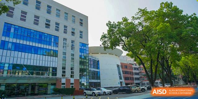 The modern exterior of a multi-story school building at Wuhan Foreign Languages School International Division.