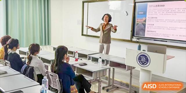 A teacher at Beijing Xin Fuxue International Academy gives a presentation in a science classroom.