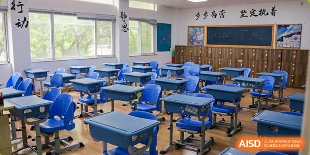An empty classroom at Xi'an Jiaotong-Liverpool University Affiliated School (XJTLU-AS) with desks and chairs neatly arranged.