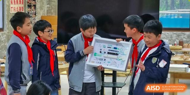 A student from Xi'an Jiaotong-Liverpool University Affiliated School (XJTLU-AS) proudly shows a project he has built.