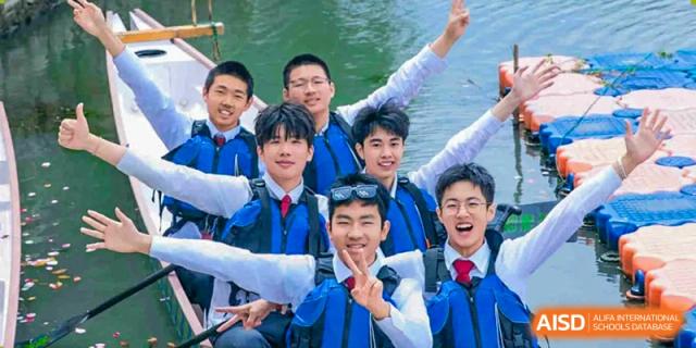 A group of male students from Xi'an Jiaotong-Liverpool University Affiliated School (XJTLU-AS) are smiling broadly for a group photo while on the water in a boat.
