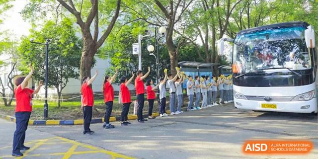 A group of students from Xi'an Jiaotong-Liverpool University Affiliated School (XJTLU-AS) participating in a team activity outdoors.