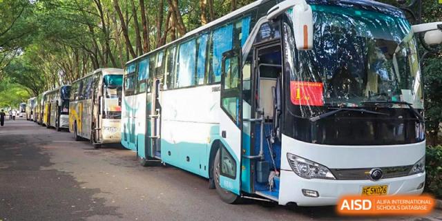 A school bus belonging to Xi'an Jiaotong-Liverpool University Affiliated School (XJTLU-AS) is parked.