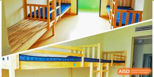 An empty dorm room with bunk beds at Xi'an Jiaotong-Liverpool University Affiliated School (XJTLU-AS).