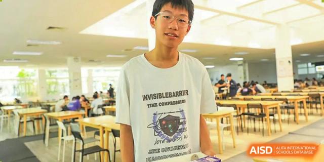 A male student from Xi'an Jiaotong-Liverpool University Affiliated School (XJTLU-AS) is standing in a dining area.