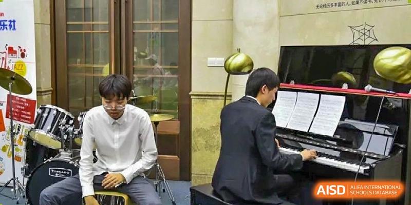 A student or faculty member playing a piano on stage or in a performance space, seen from the side at Wuxi No.1 High School.