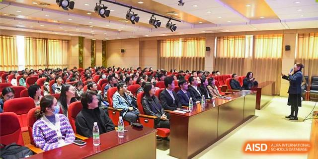 A large audience of students and faculty seated in an auditorium listening to a lecture or presentation at Wuxi No.1 High School.