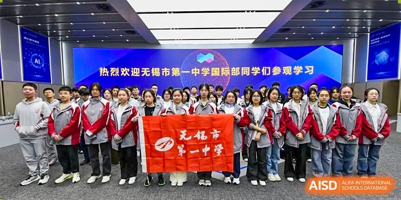A large group of high school students holding a red banner welcoming students from a sister school or program at Wuxi No.1 High School.