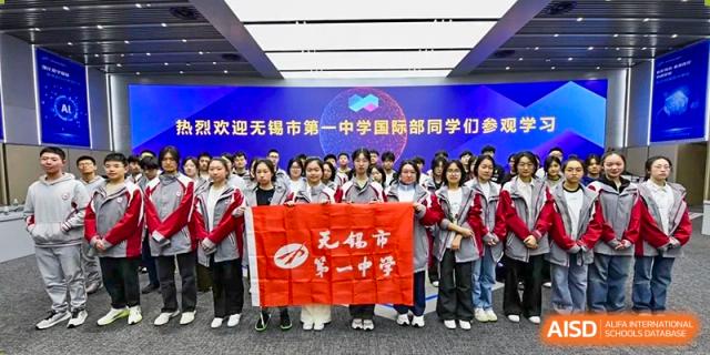 A large group of high school students holding a red banner welcoming students from a sister school or program at Wuxi No.1 High School.