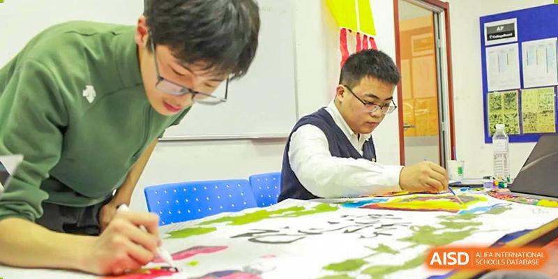 BaiShan AWS High School students work on a creative project in a classroom.