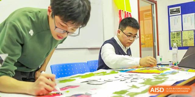 BaiShan AWS High School students work on a creative project in a classroom.