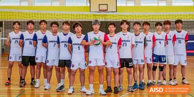 A volleyball team from BaiShan AWS High School poses for a photo after a game.