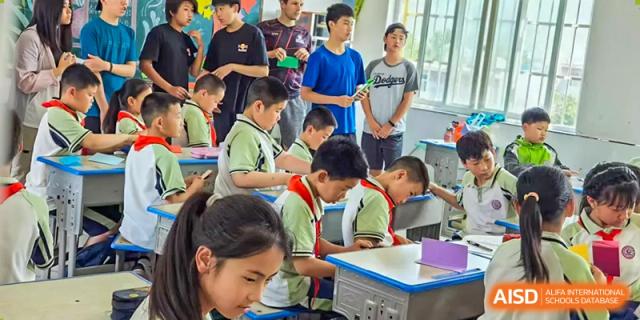 A teacher is helping students with a project or assignment in a classroom at Chengdu International School.