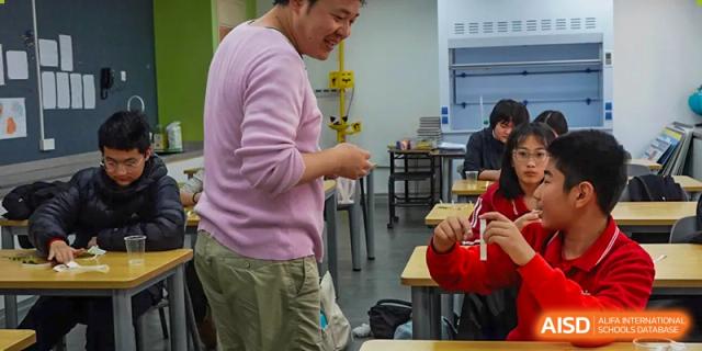 A teacher is standing in a classroom and talking to students at Chengdu International School.