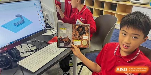 A student is holding a book and pointing at a page at Chengdu International School.