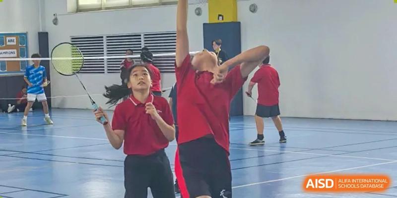 A student from Chengdu International School jumps to block a shot during a volleyball game.