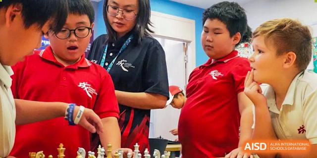 Students in red shirts are participating in a cooking activity at Chengdu International School.