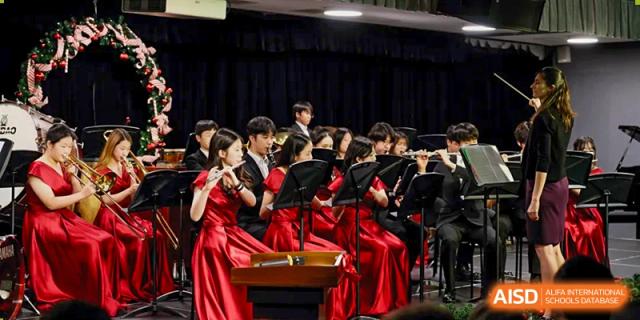 A student orchestra is performing on a stage at Chengdu International School.