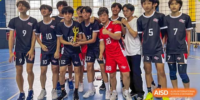 A group of male students in volleyball uniforms is posing for a team photo at Chengdu International School.