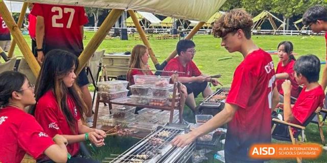 Students are barbecuing on a grill outdoors at Chengdu International School.