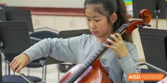 A student at Shanghai American School is focused on playing a cello.