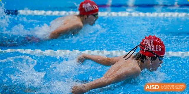 A student from Shanghai American School is swimming during a competition.