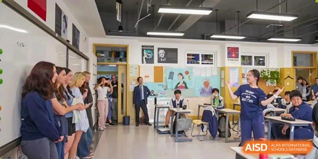 Students and faculty members in a modern, open-concept classroom or workspace, Beijing Etown Academy International Department