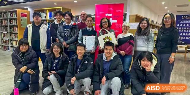 A large, diverse group of students, adults, and faculty posing for a group photo at a school event, Beijing Etown Academy International Department