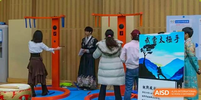 Students or attendees outdoors; one is wearing a white winter jacket, and another is in a black and white traditional dress, Beijing Etown Academy International Department