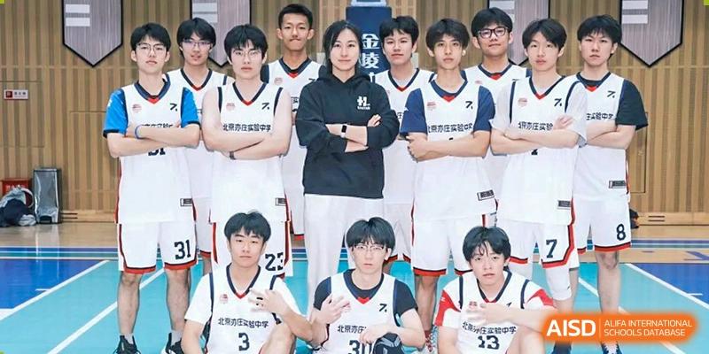 A group of male basketball players in white and red uniforms posing for a team photo, Beijing Etown Academy International Department